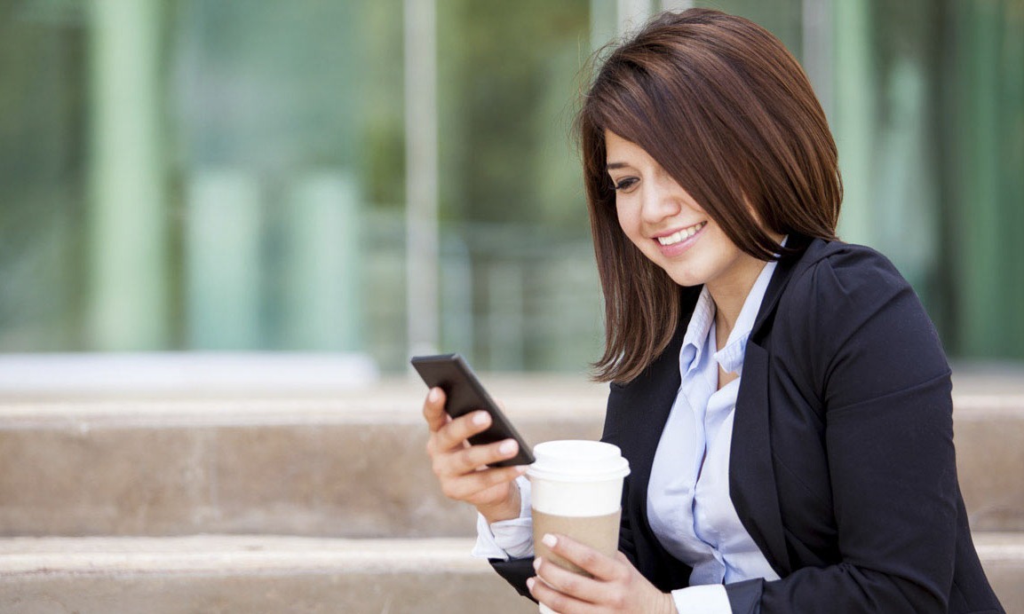 Woman on cell phone with coffee