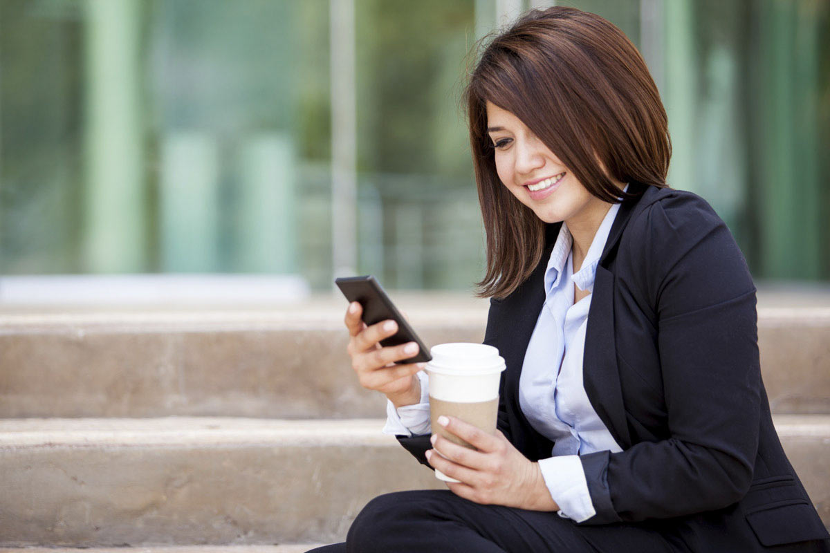Woman on cell phone with coffee